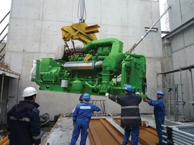 Crew rigging a cogeneration engine into place