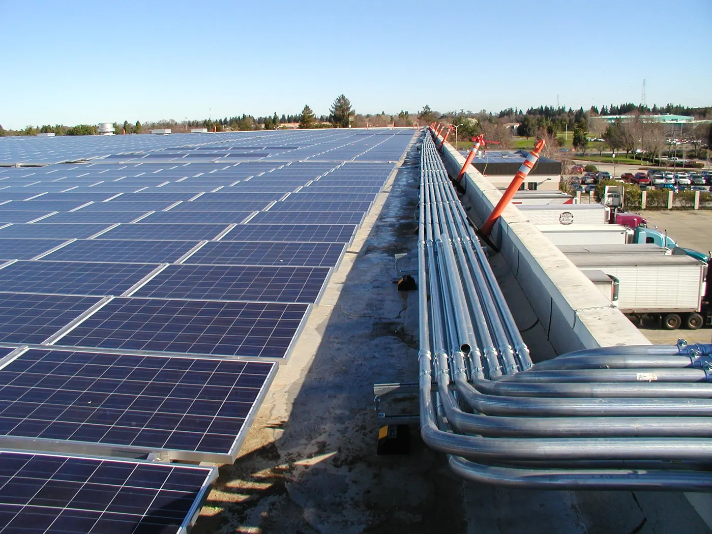 Long rooftop solar array with conduit runs